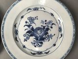 two plates with blue and white designs on them on a table