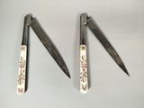 three pairs of scissors sitting on a white surface