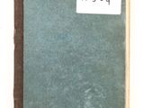 a green book with black writing on it sitting on a table