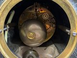a clock that is sitting inside of a metal case