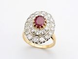 an oval ruby and diamond cluster ring