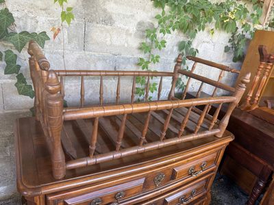 a bed with a wooden frame on top of a dresser