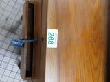 a wooden box with a number on it sitting on a tile floor