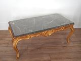 a marble top coffee table on a wooden floor