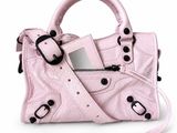 a small pink purse with a mirror on it