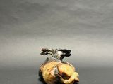 a small figurine of a bird that is sitting on top of a banana