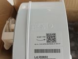 a box with a white electronic device inside of it