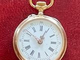 une montre de poche en or avec des chiffres romains