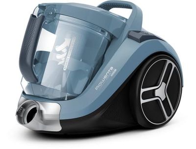 un gros plan d'un aspirateur bleu et noir posé sur une surface blanche