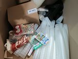a cardboard box filled with plastic cups and other items
