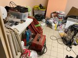 a room with a lot of clutter and tools on the floor