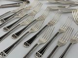a lot of forks and spoons that are on the table
