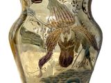 a glass vase with a bird design on it