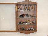 a wooden cabinet with a mirror and many pairs of scissors on it