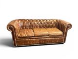 an image of a brown leather couch sitting on top of a white floor