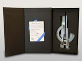 a box with a pen and a microscope inside of it