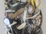 a bag of assorted watches and other items in it