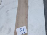 a piece of wood laying on the ground next to another piece of wood