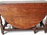 a small wooden table with a wooden top on a white surface