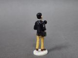 a figurine of a man with a bag on a table