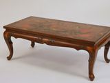 a small wooden table with a floral design on it