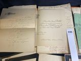 some old papers are sitting on top of a black table