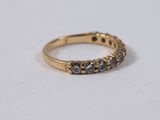 a close up of a gold ring with black diamonds on it
