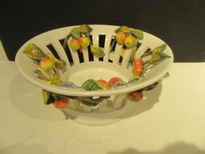 a white bowl with flowers on it sitting on a table