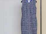 the vest is hanging on a clothes rack in a room