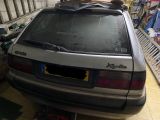 a car with a surfboard on top of it in a garage