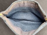 the inside of a purse with a hand holding it