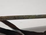 someone is holding a pair of scissors with writing on it