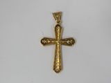 a gold cross pendant with a skull on it