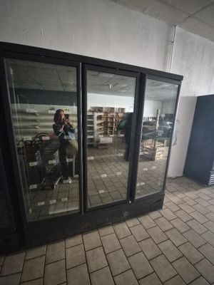 a person sitting in a chair in a room with a large window