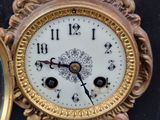 a clock that is sitting on a table with a mirror