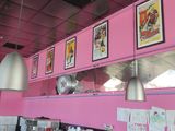 pictures on the wall above the counter in the restaurant