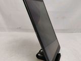 a close up of a tablet computer on a stand on a white surface