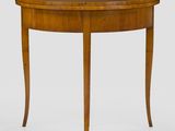 a wooden table with a curved top and curved legs