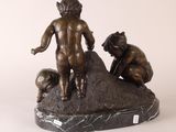 bronze statue of a boy and a boy kneeling on a rock
