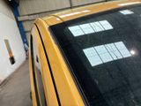 a yellow taxi cab parked in front of a building