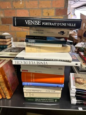 many books stacked on top of each other on a table