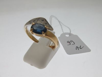 a gold ring with a blue stone on it and a price tag