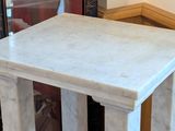 a marble table with a marble top in a room