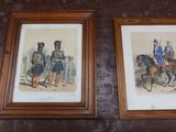 two framed pictures of men in uniforms on a wall