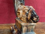 a statue of a ram with a horn on a table