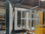 a picture of a warehouse with a forklift in the middle of the room