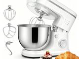 a white mixer with a metal bowl and a pastry scooper