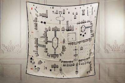 a black and white picture of a quilt hanging on a wall