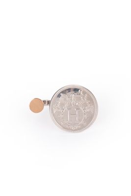 a close up of a coin on a white surface