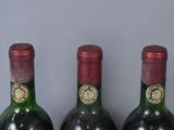 three bottles of wine that are sitting on a table